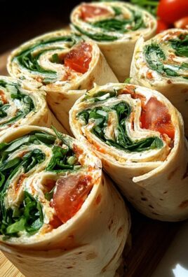 Vegetarische Wrap-Röllchen mit Rucola und Tomaten